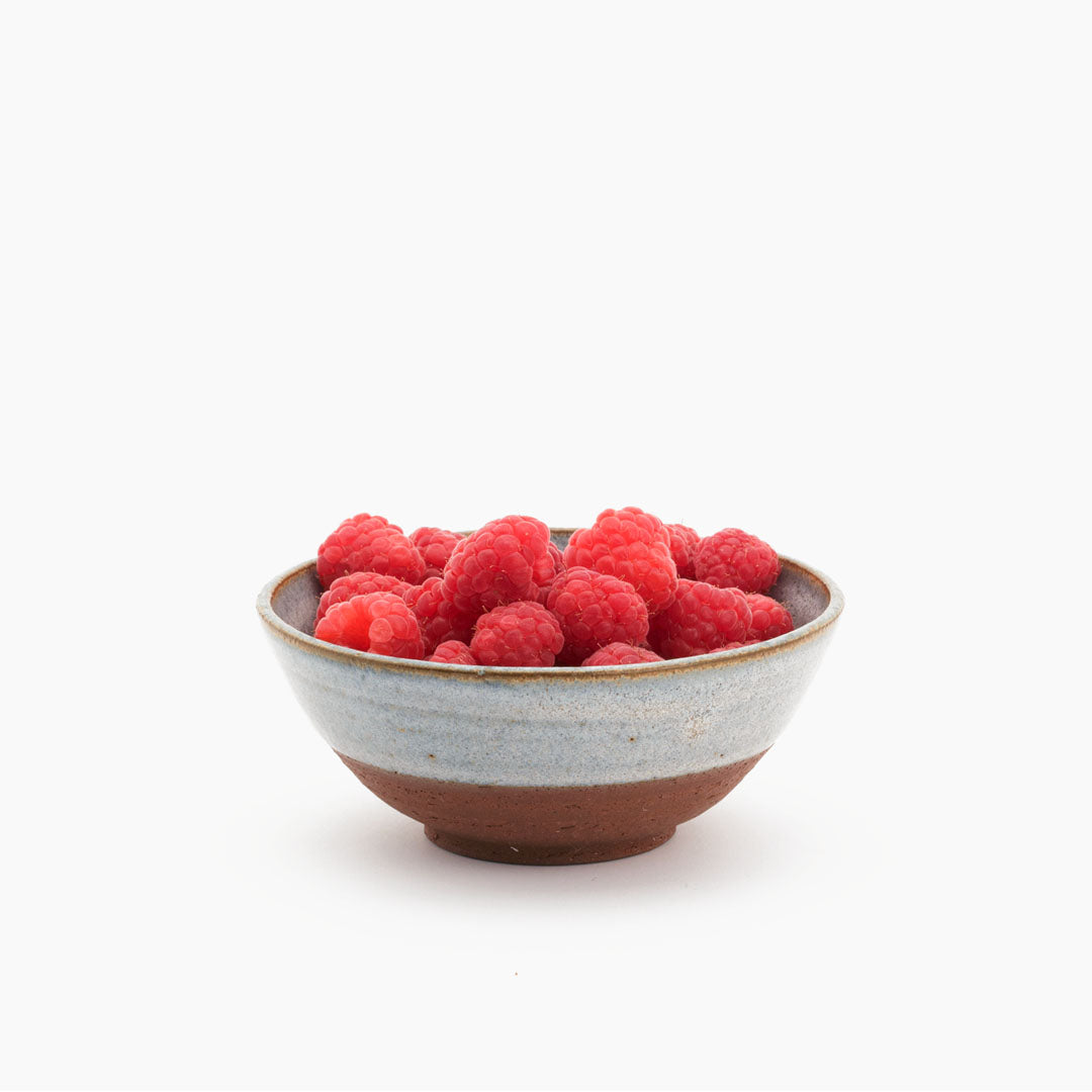 Hover image of a Blå collection breakfast bowl, filled with raspberries.