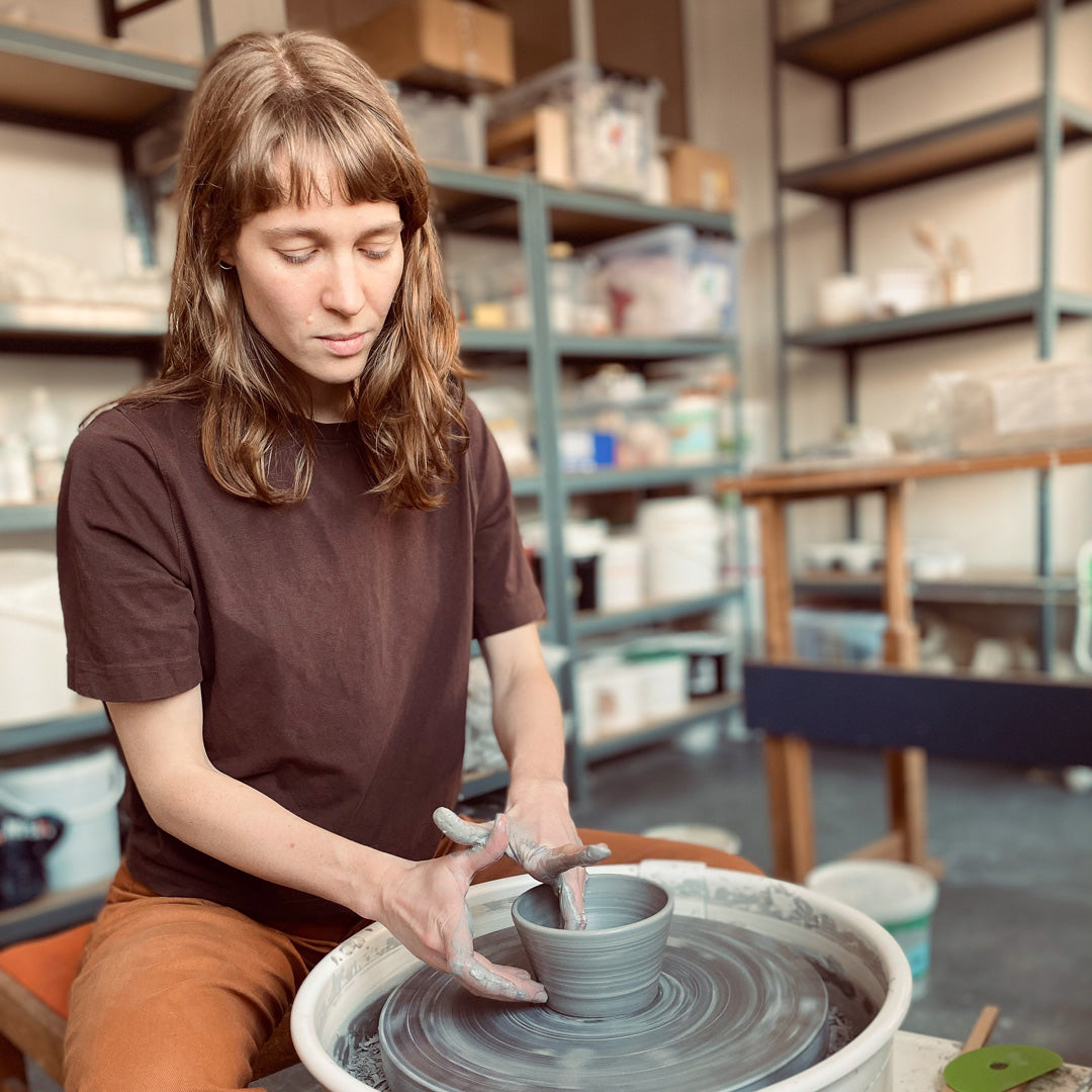 Amalie spinning a bowl at her studio.