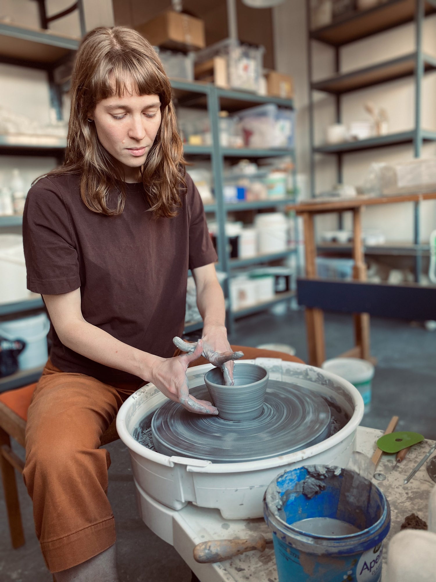 Amalie spinning a bowl at her studio. 